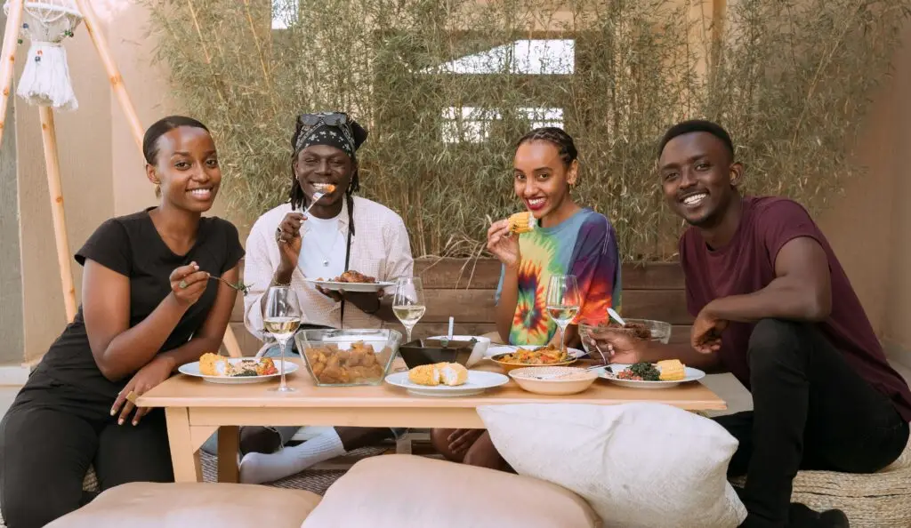 Group of Kenyans sharing a meal — the cost of food in Kenya varies by dish and location