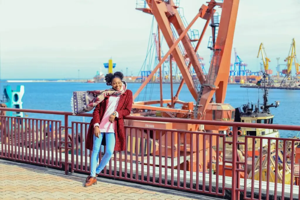Woman leaning on a railing at the dock - budget travel in Kenya