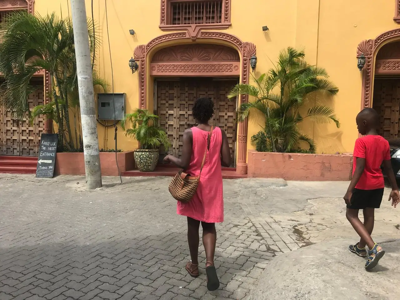 A woman and a young boy walking in Old Town Mombasa