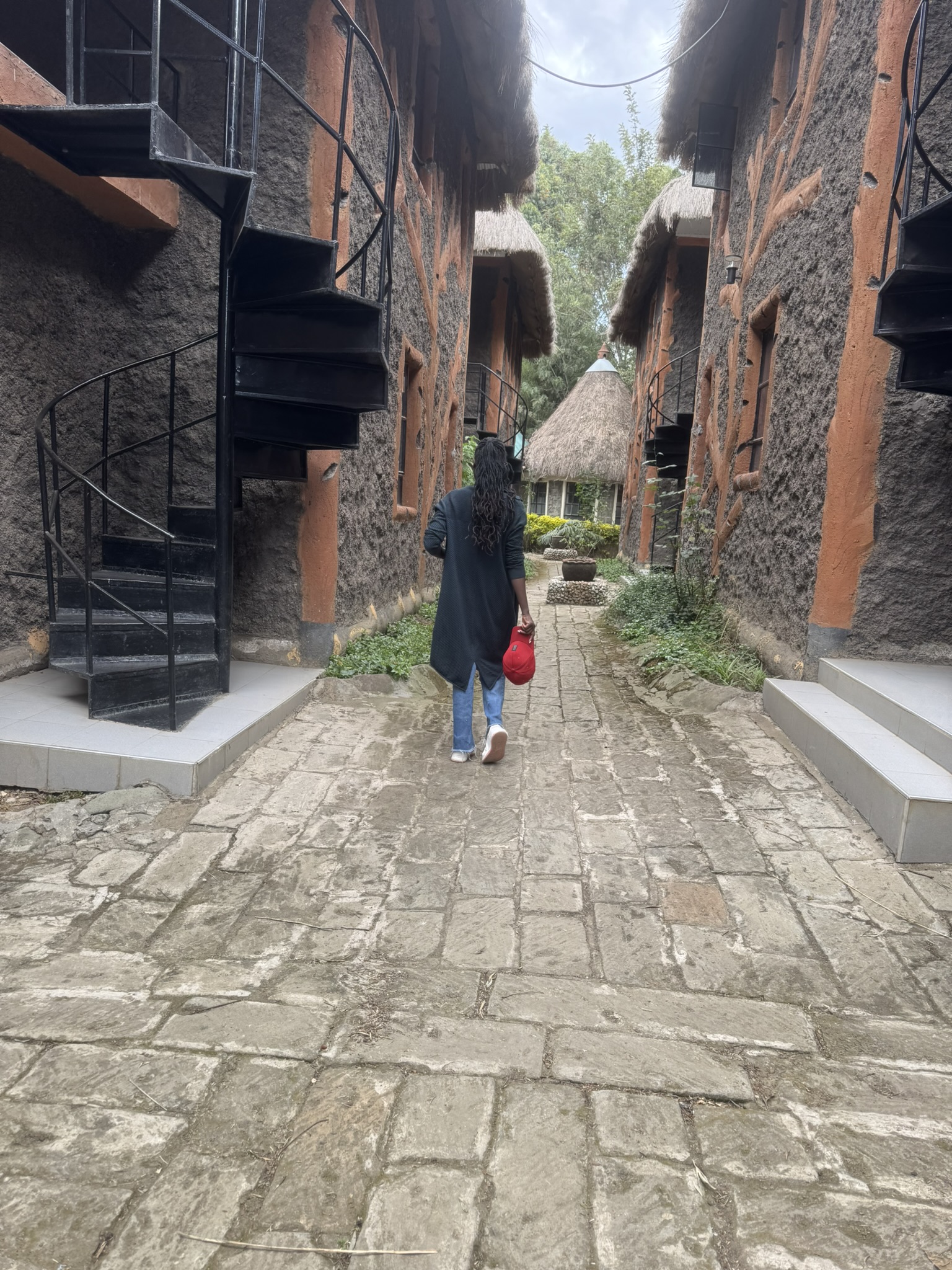 A woman walking between lodges