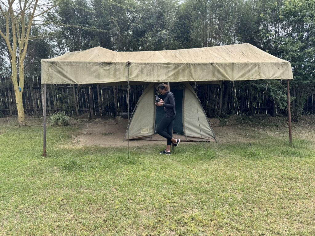 A woman standing in front of a tent 