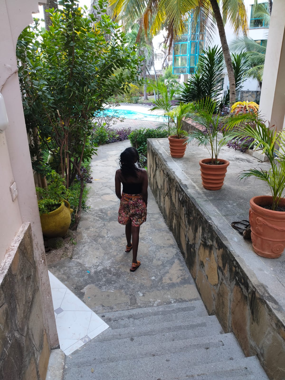 A woman walking to wards a swimming pool
